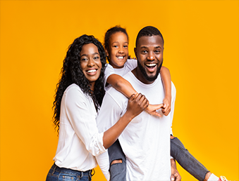A picture of a black family together smiling with a gold background.